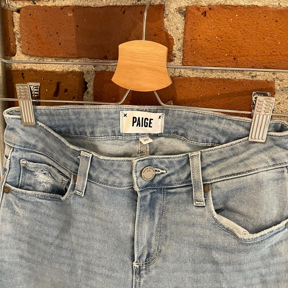 Light wash distressed blue Paige denim